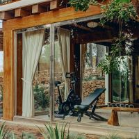wellness areas span a gym, yoga deck, steam room, sauna, and treatment huts